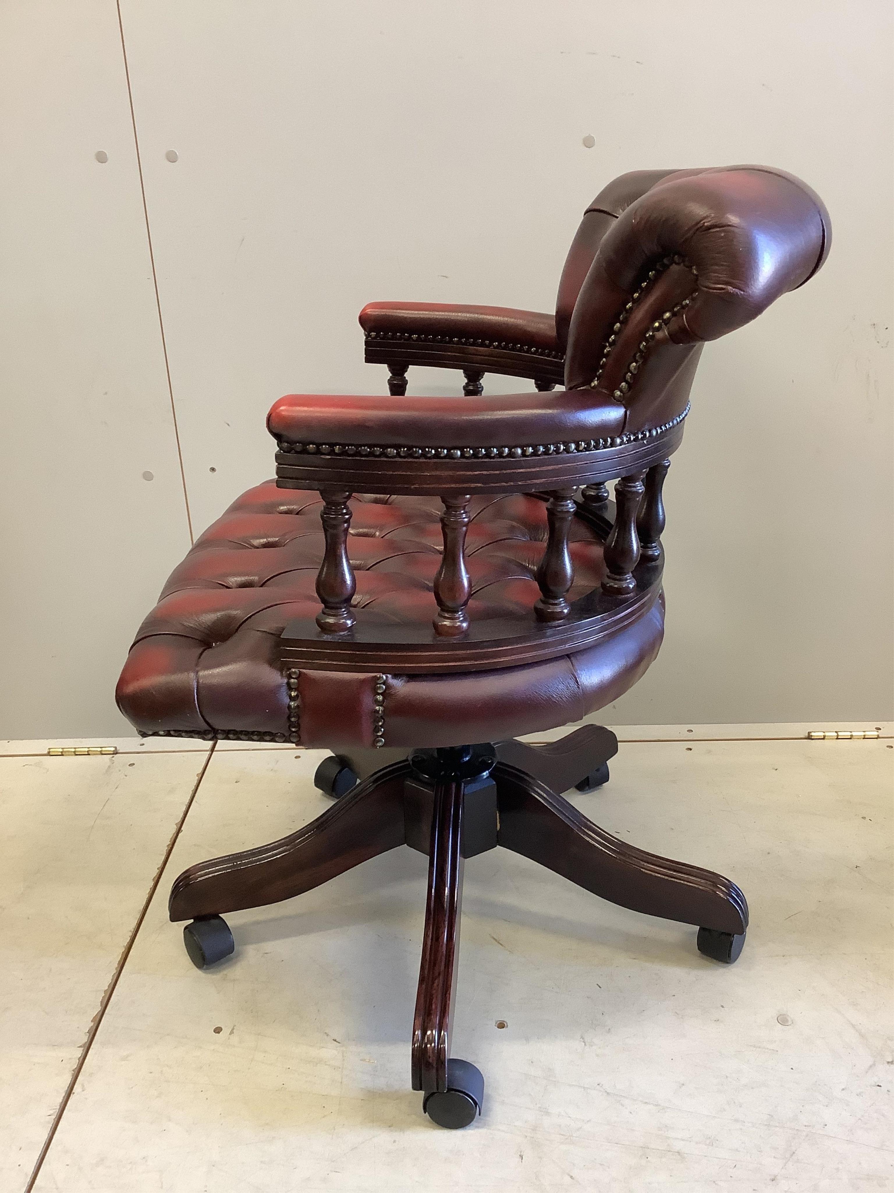 A reproduction Victorian style beech and burgundy leather swivel desk chair, together with a reproduction mahogany pedestal desk, width 121cm, depth 61cm, height 76cm